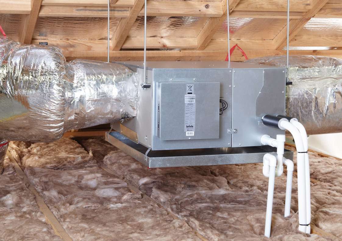 Ducted indoor unit with a safety drain tray beneath it and the main drain line